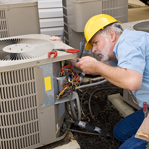 An air conditioning technician working on an air conditioner